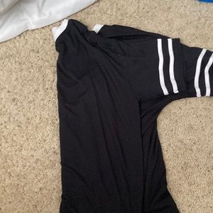 A black Tee with two white stripes on the sleeves